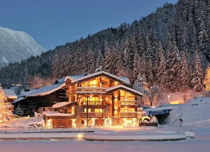 An illuminated private chalet in winter