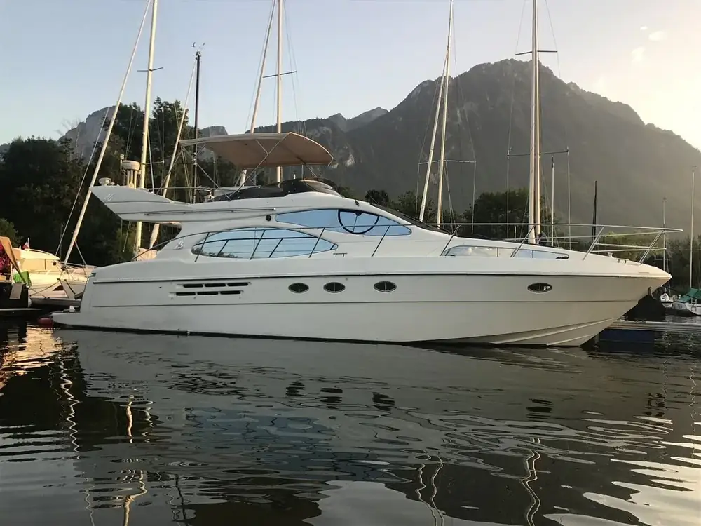 A private yacht on Lake Geneva with mountains beyond